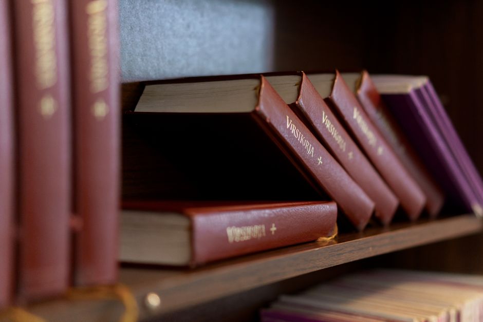 A black and white close-up of a bookshelf filled with diverse books, showcasing a variety of literature.