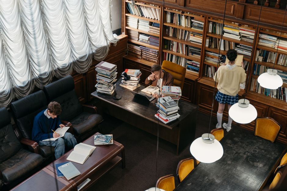 Elegant interior of a historic library in Hawarden, showcasing wooden architecture and bookshelves.